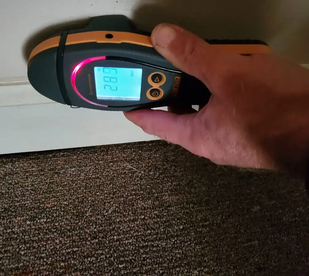 Moisture detection at baseboard during Storm Damage Restoration in Seal Beach